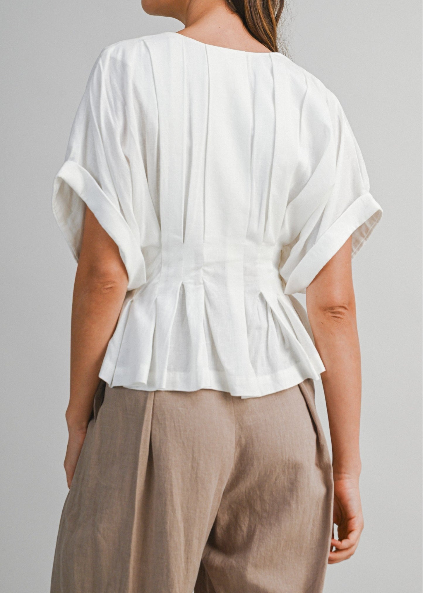 IVA PLEATED PEPLUM TOP